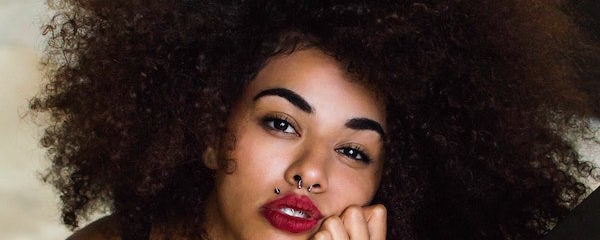 woman with lip and septum piercing