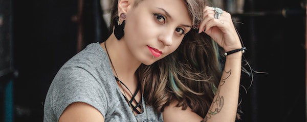 pierced girl with head rested on hand