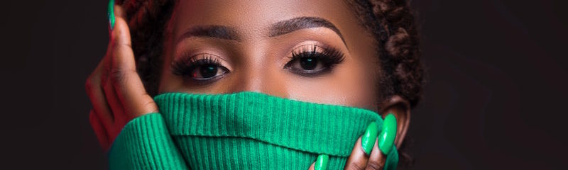 woman covers face with turtleneck