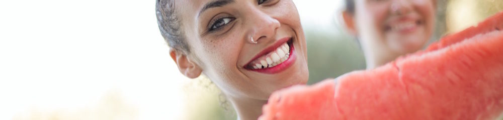 Girl with Nose Piercing Holds a Watermelon