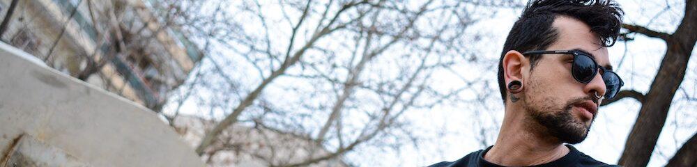 Man with septum piercing and stretched lobes