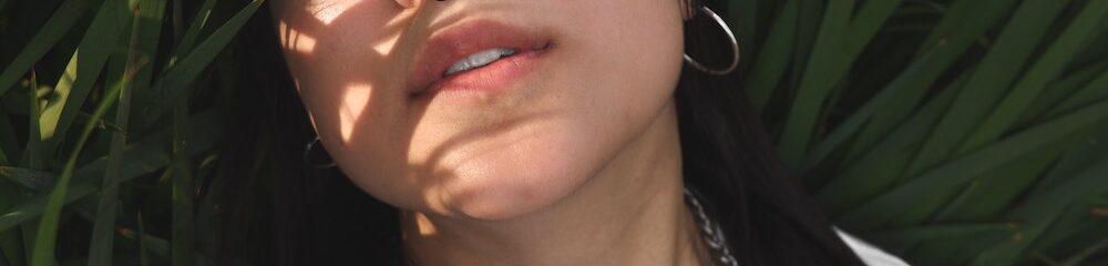 woman with septum and ear piercing