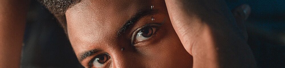 Man with nostril and eyebrow piercings