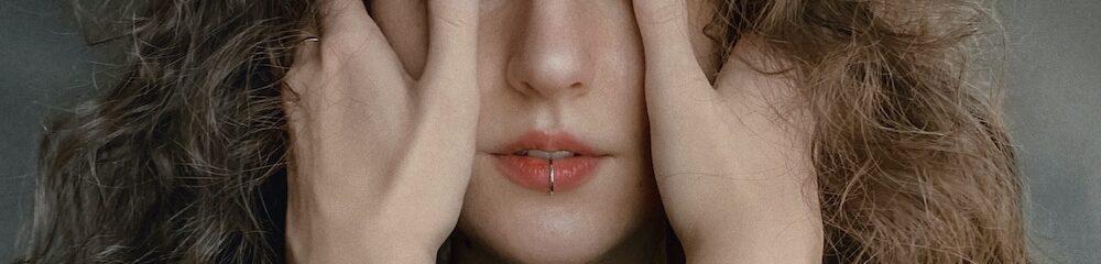 Woman with labret piercing decorated with hoop