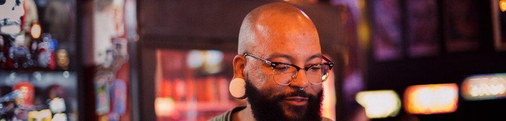 Man with stretched lobes and septum piercing