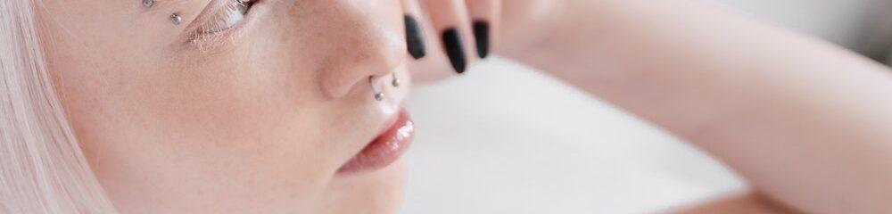 Woman with septum piercing and eyebrow piercing