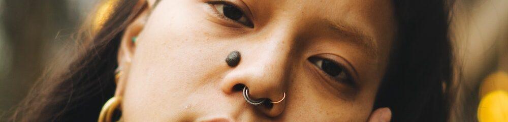 Woman with septum, nostril, and ashley piercings