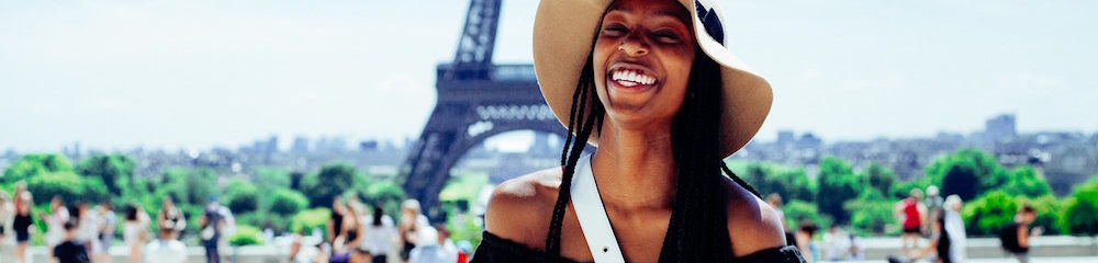 Woman Smiling in Front of Eiffel Tower