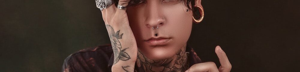 Man with septum piercing and multiple other piercings