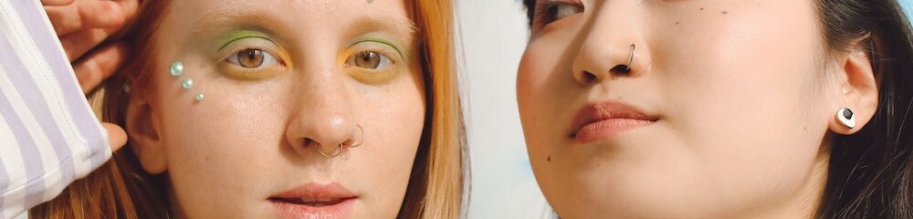 Two women with nose piercings