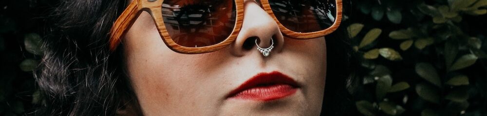 Woman in sunglasses with septum piercing