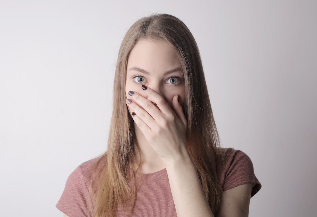 woman covering her mouth