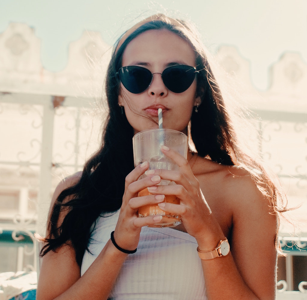 Woman drinking from a straw