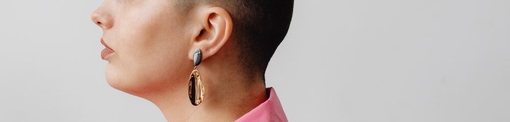 Woman with lobe piercing dangle earring