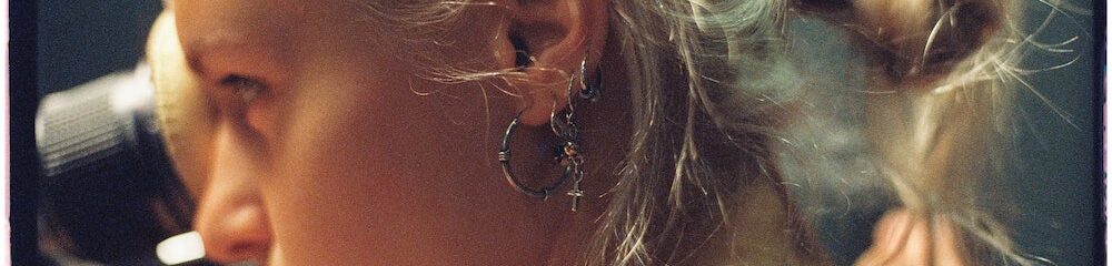 Woman with multiple lobe piercing hoops