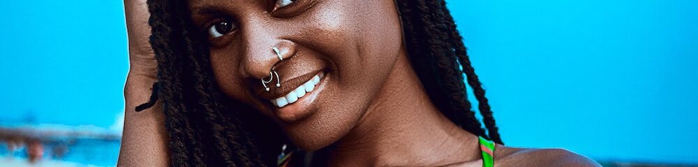 Woman with multiple nose piercings at the beach