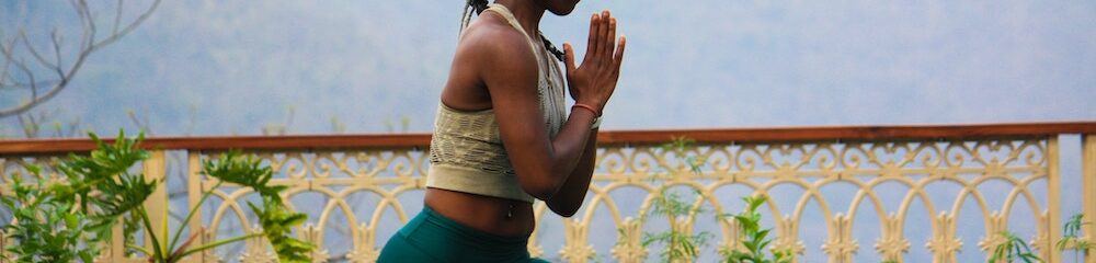 Woman with ear piercings doing yoga
