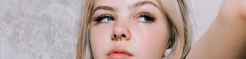 Woman with nostril and septum piercings